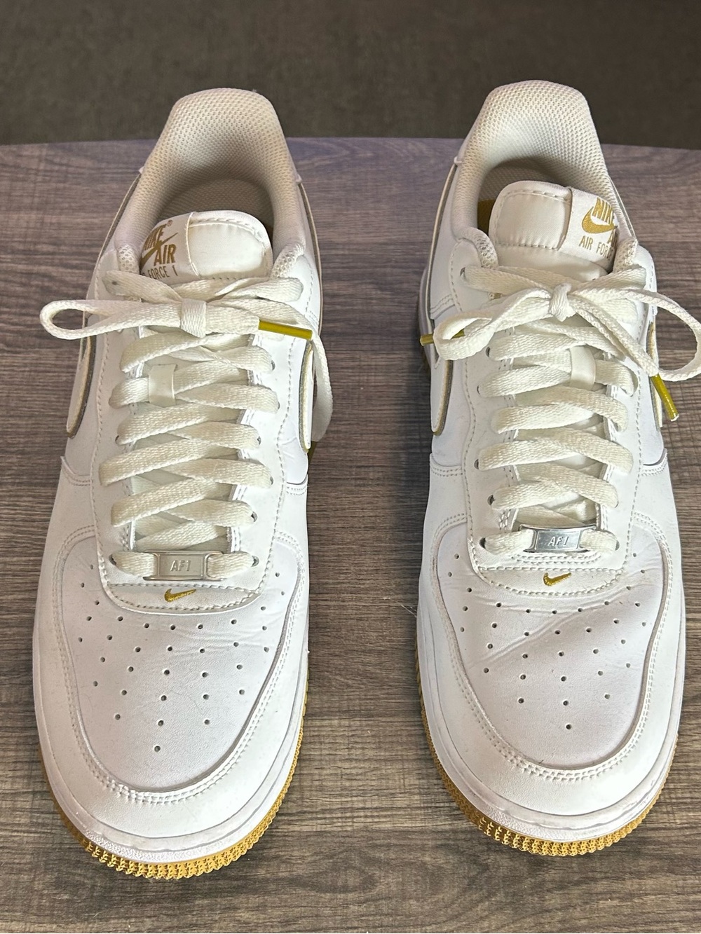 Nike White Sneakers with Gold Accents